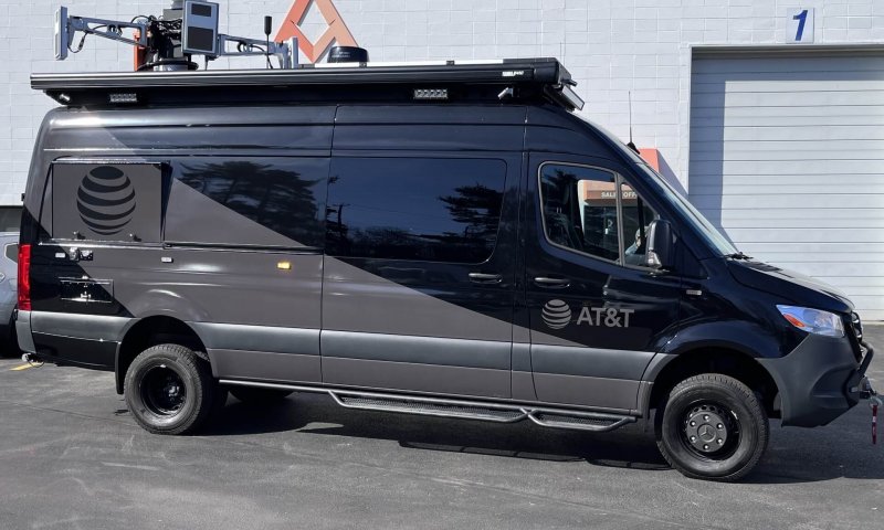A black van with a subtle AT&S logo upfitted with counter-unmanned aerial system (C-UAS) technology