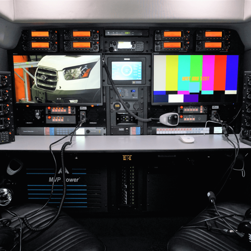 interior-workstation-with-mvp-e-power The interior of a mobile command & operations vehicle with two ergonomic swivel chairs, two large screens, and AMT's MVP-E™ Power System.